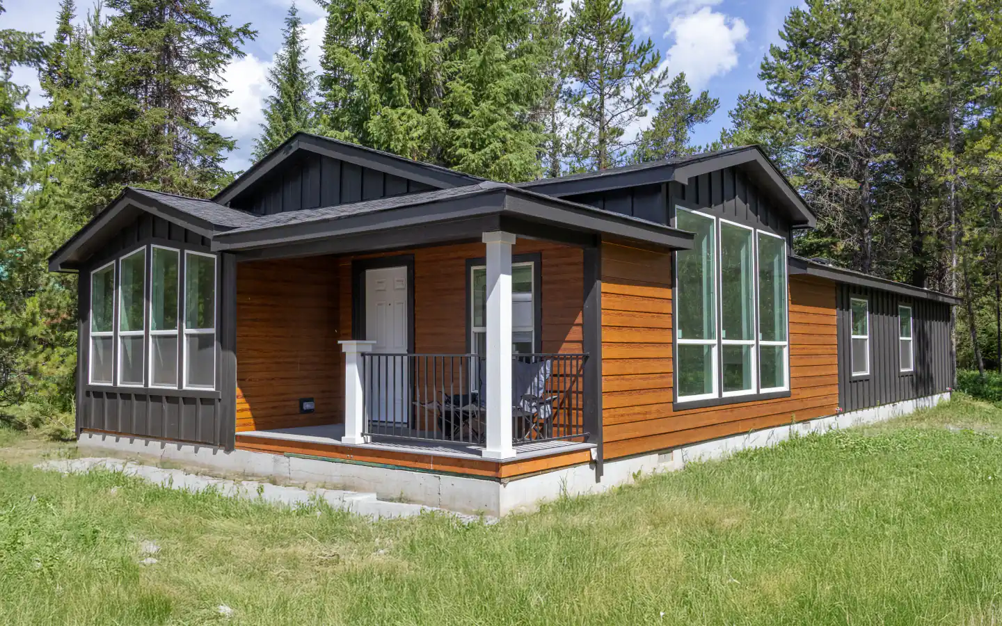 Manufactured home with a covered porch in a wooded setting