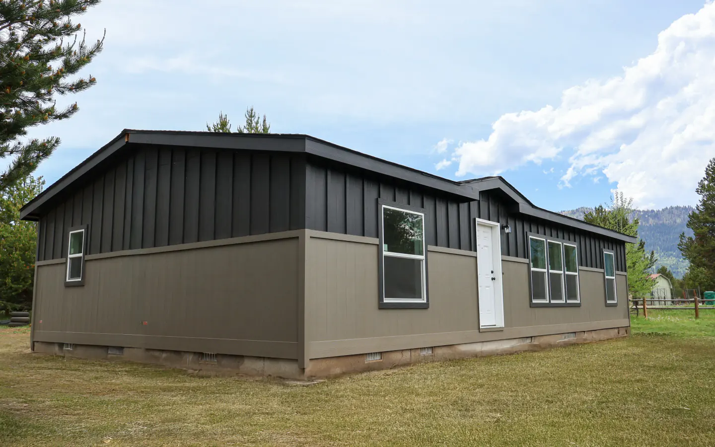 Manufactured home installed on an Idaho property with mountains nearby